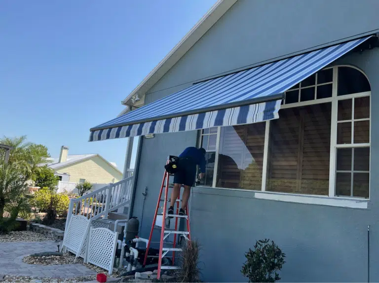 Cleaning a retractable awning on a home exterior