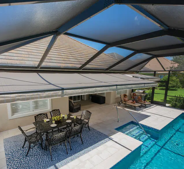 Retractable awning installed under a screened pool enclosure